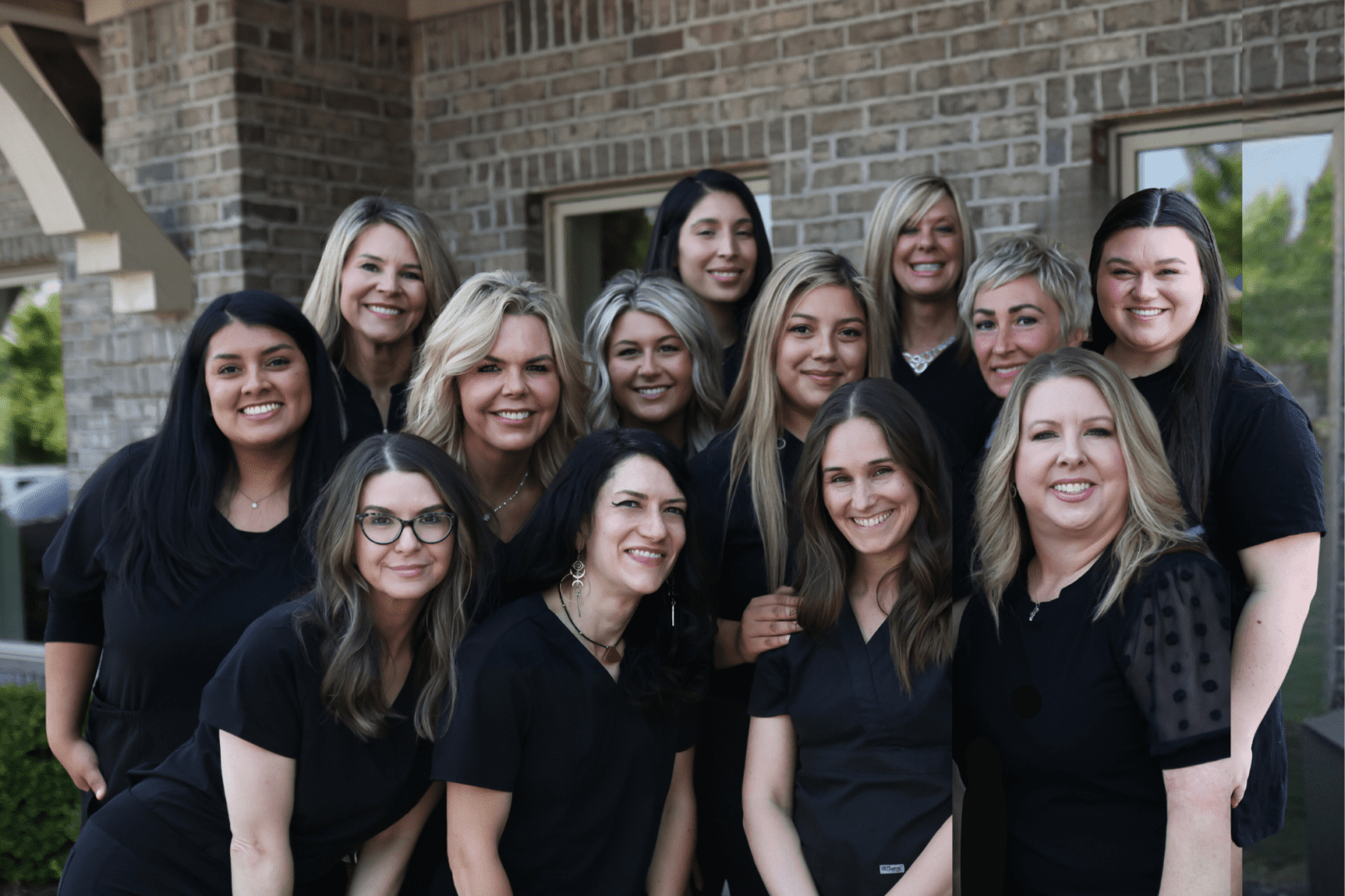 Group of smiling women in black tops