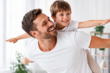 Father giving son a piggyback flight